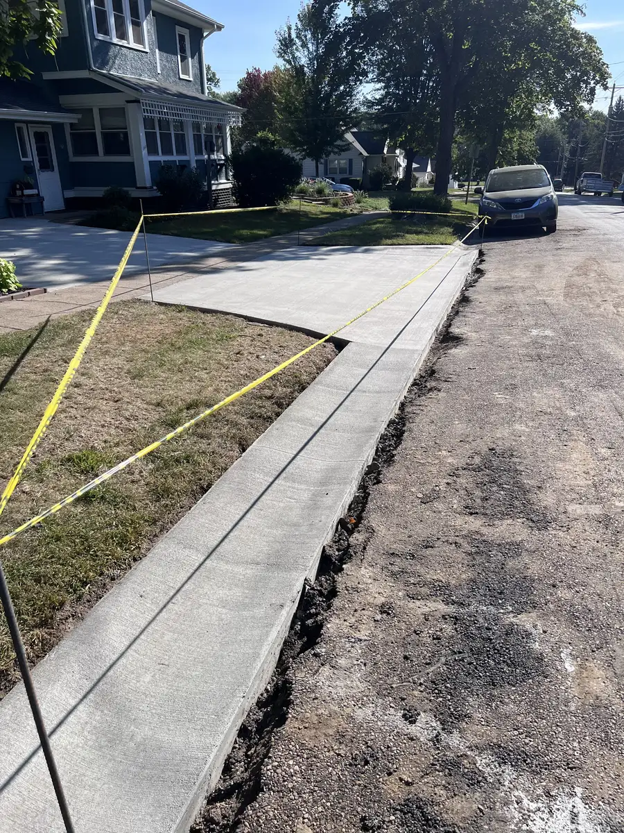 Replaced concrete sidewalk along a residential street