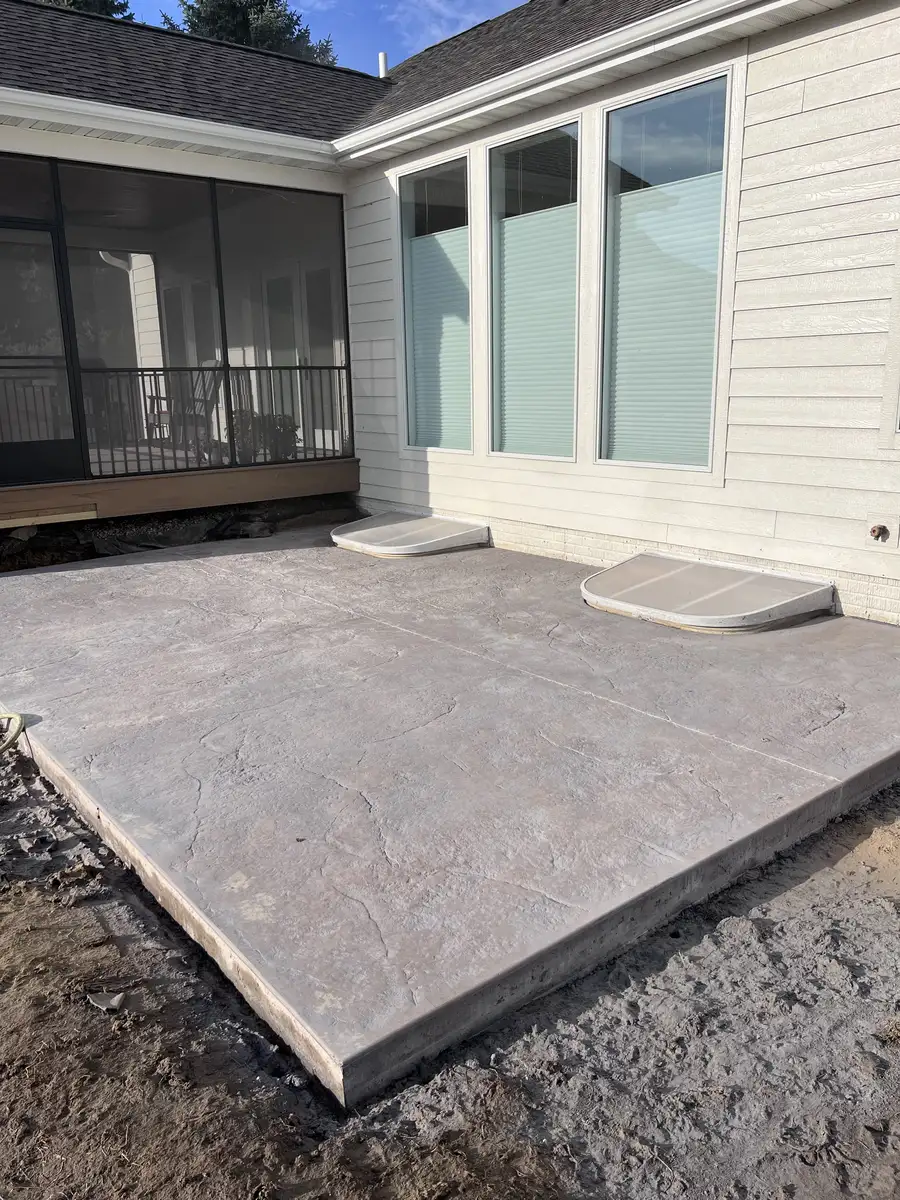 New concrete patio and step off a screened porch