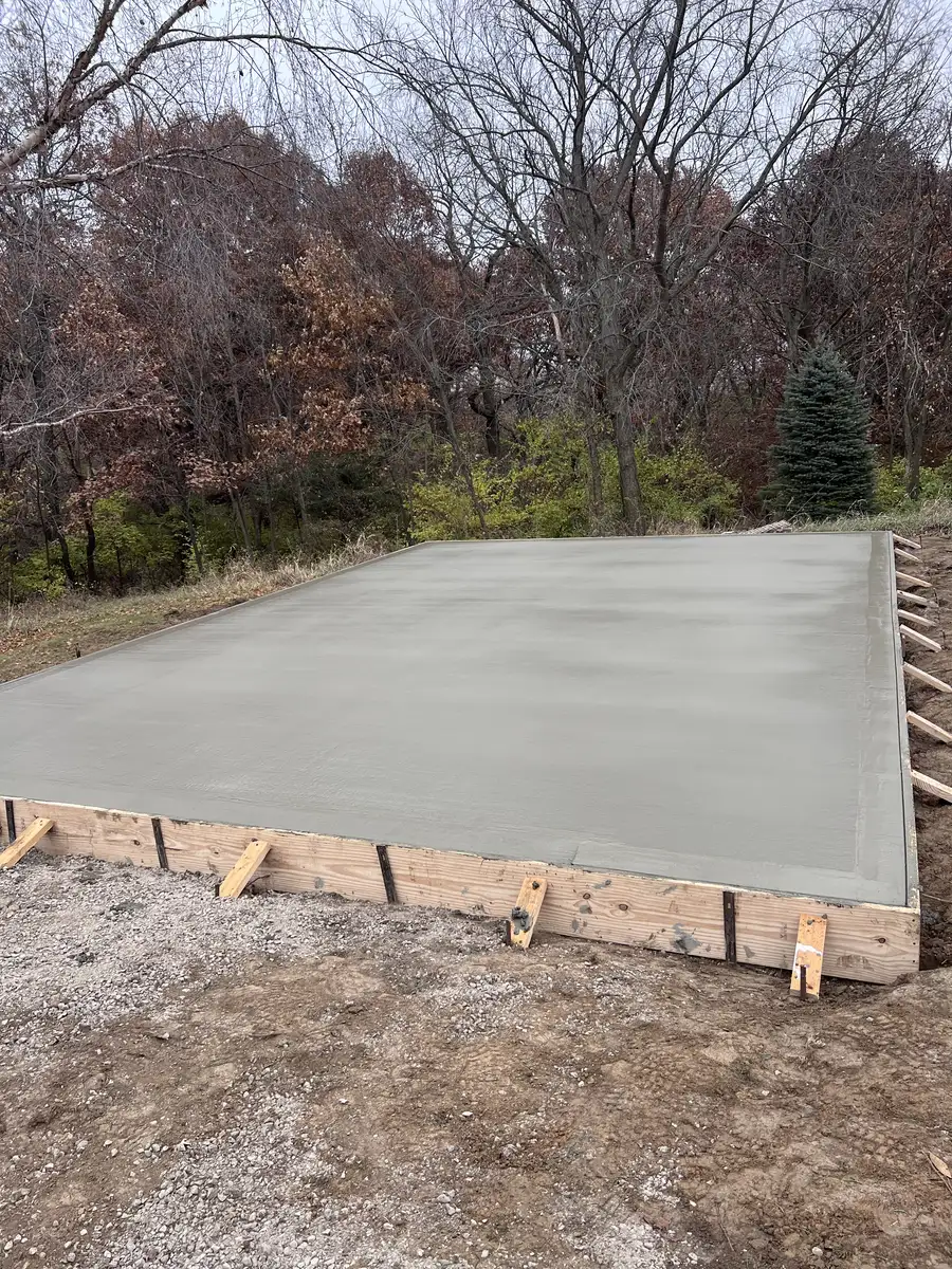 Concrete slab with wood forms set in a wooded lot